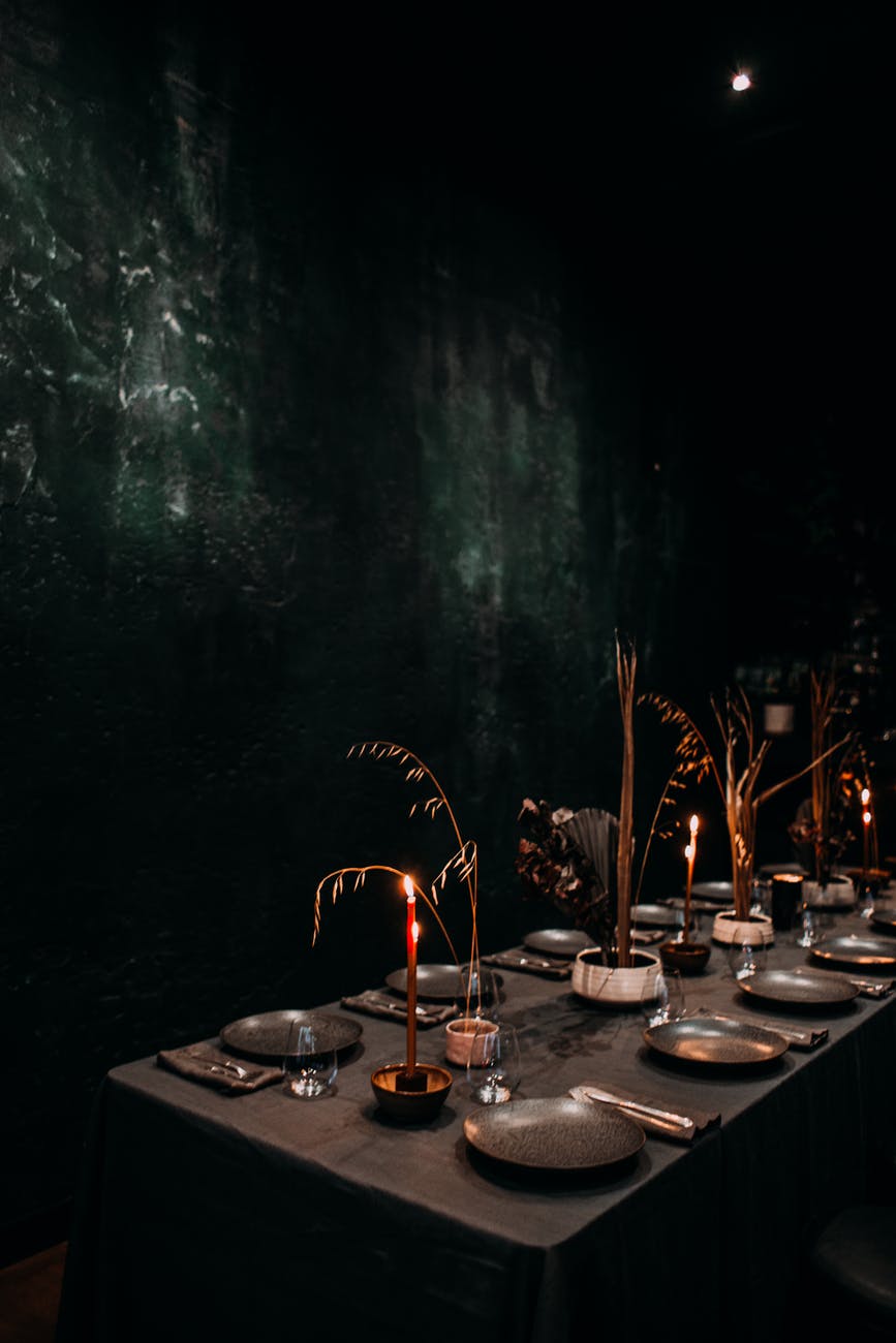 banquet table with candles in dark room
